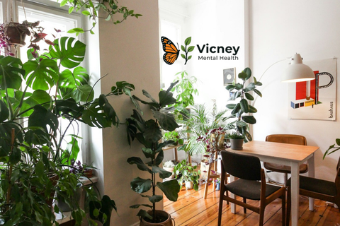 default Bright, plant-filled room with a table, chairs, and the Vicney Mental Health logo on the wall