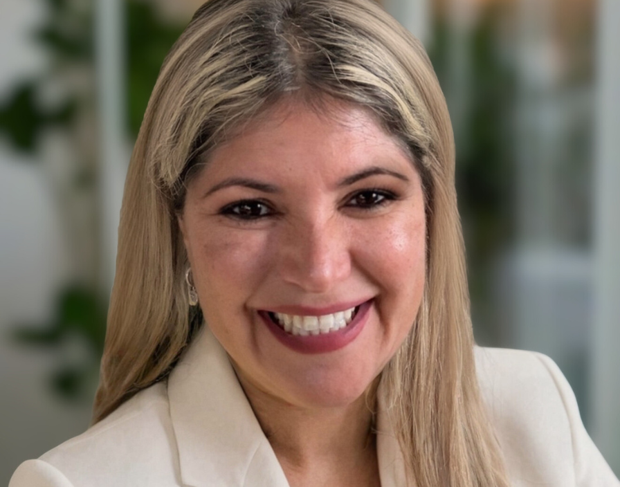 Yeney representative of Vicney Yeney, a representative from Vicney, smiling in a professional portrait, wearing a light-colored blazer and with a blurred office background.