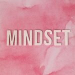 Inspirational mindset text on pink watercolor background for motivational themes.